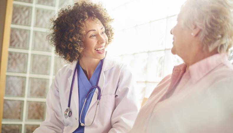 Woman Physician Speaking to Woman Patient