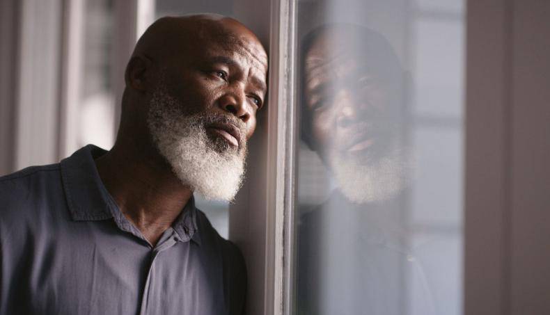 Senior Looking Outside Window