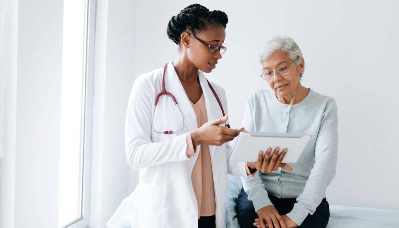 Doctor Showing Patient Results on Tablet