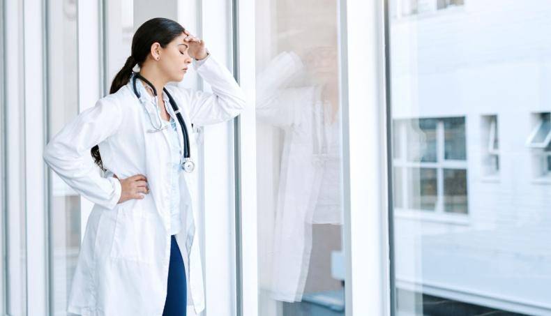 Physician With Hand on Forehead