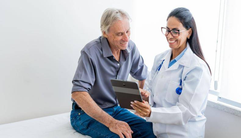 Doctor Showing Patient Tablet