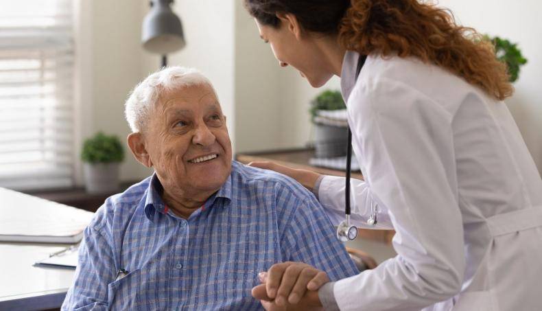 Doctor helping old man