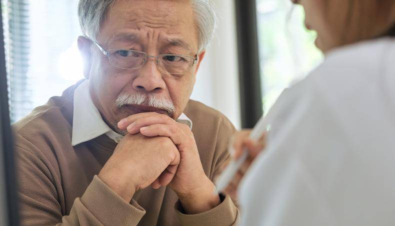 Senior speaking with a doctor about the importance to access to healthcare