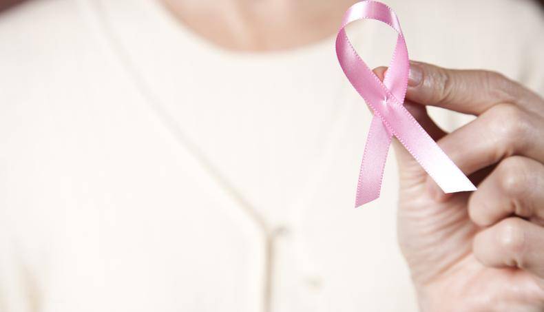 Woman holding breast cancer ribbon