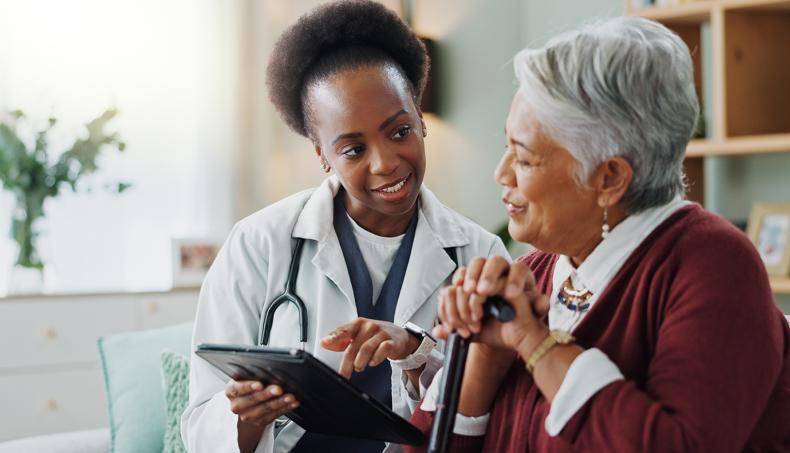 Doctor speaking with senior patient about utilizing health technologies