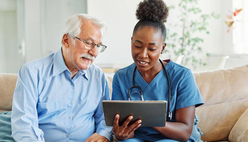 Doctor and patient sitting reviewing documents