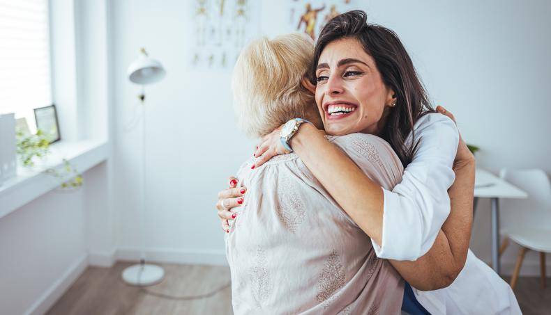 Woman doctor comforting patient with a hug