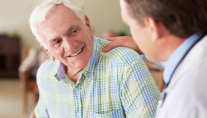 Physician reassuring a patient with a pat on the back