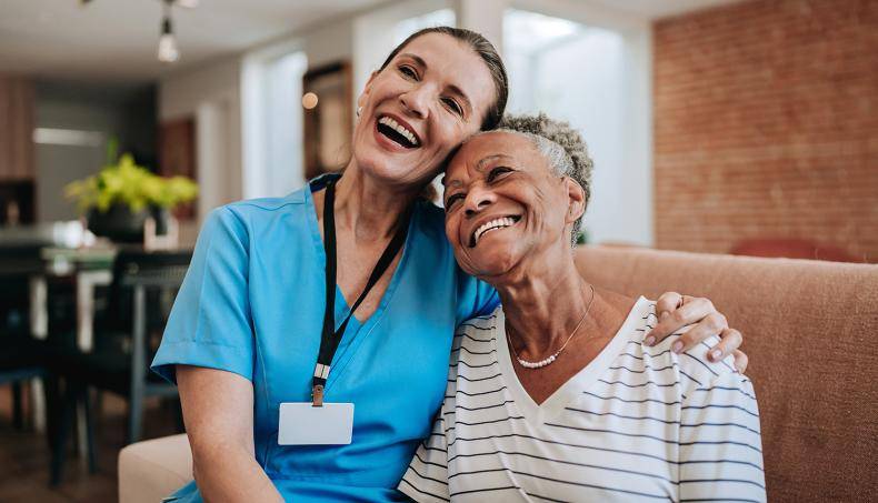 Social worker and patient seated, smiling gleefully
