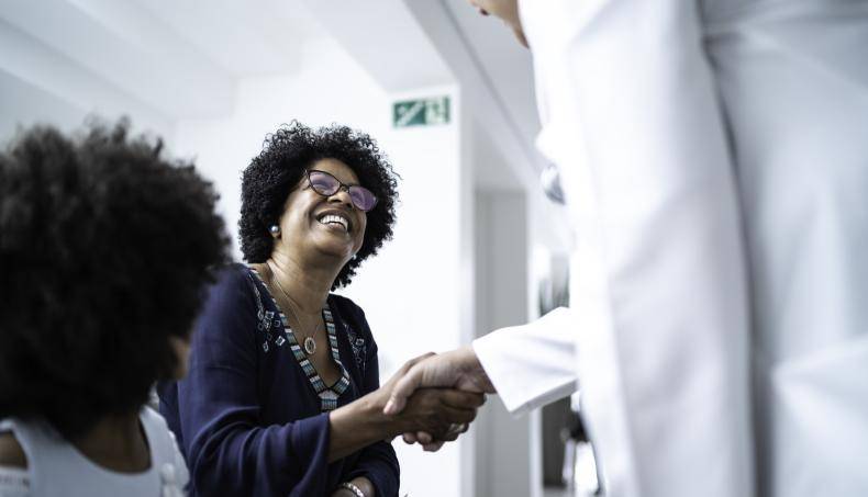Doctor shaking the hand of a senior patient