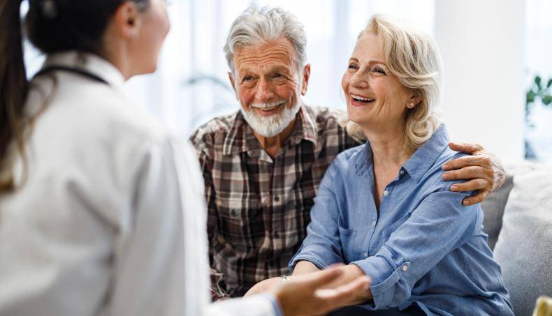 Senior couple speaking with doctor