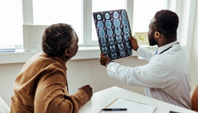 A doctor showing brain imaging to a senior patient
