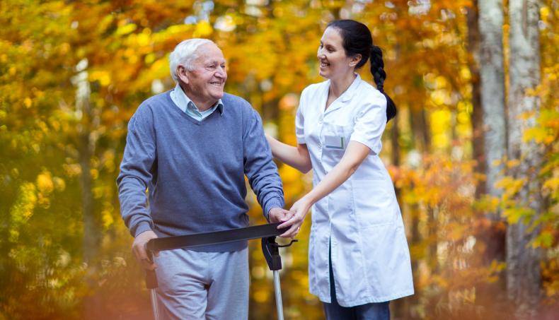 Physician walking with a patient outside in nature
