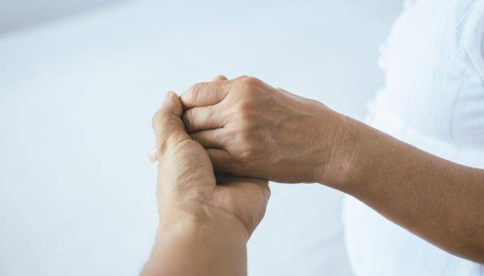 Social Worker holding patients hand