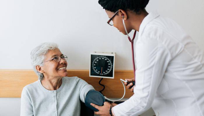 Doctor Checking Patient's Blood Pressure