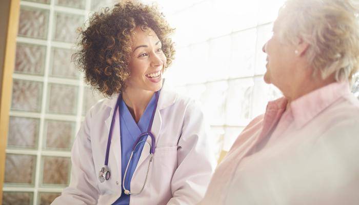 Woman Physician Speaking to Woman Patient