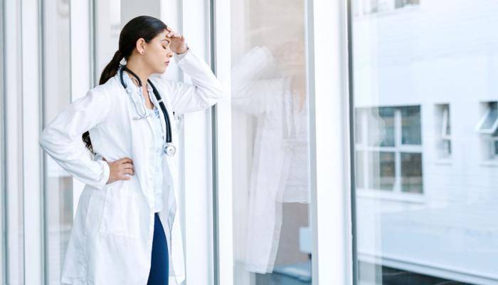 Physician With Hand on Forehead