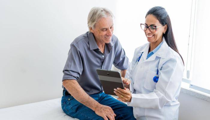 Doctor Showing Patient Tablet