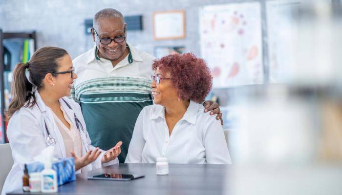Doctor Smiling at Two Senior Patients