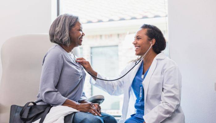Doctor Checking Patient's Heartbeat with Stethoscope