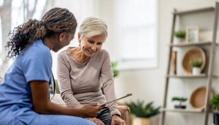Physician Showing Chart to Senior Patient