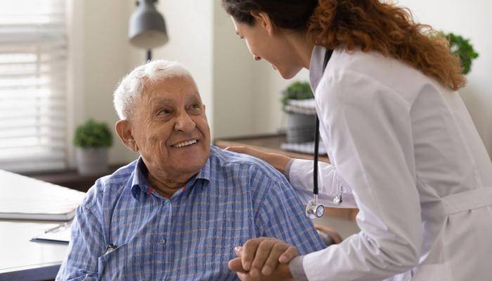 Doctor helping old man