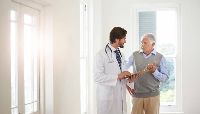 Doctor speaking with senior about chronic care mangement