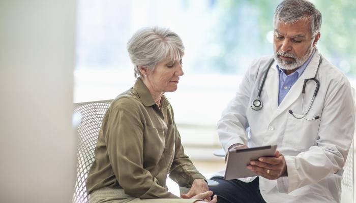 Physician speaking with senior patient about mental health.