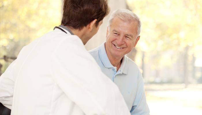 PCP speaking with a happy senior patient 