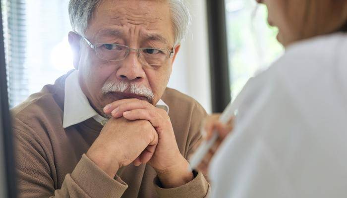 Senior speaking with a doctor about the importance to access to healthcare