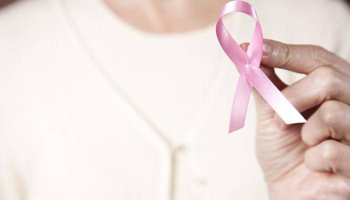 Woman holding breast cancer ribbon