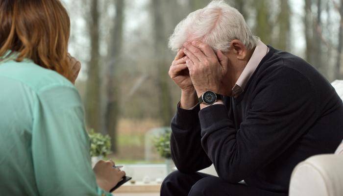 Primary care physician speaking with a senior and running a depression screening