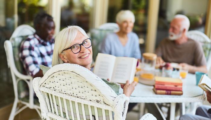 Seniors having a lovely lunch together while hosting a book club
