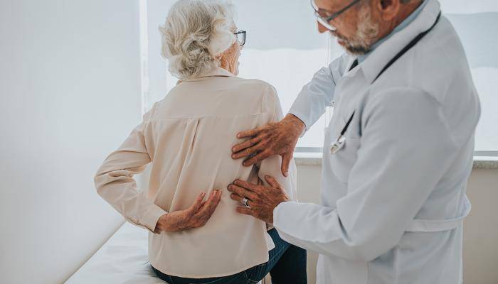 Doctor checking a patient for bone and joint decline