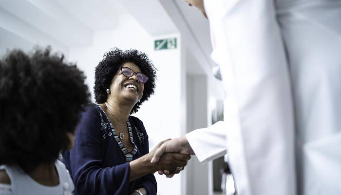 Doctor shaking the hand of a senior patient