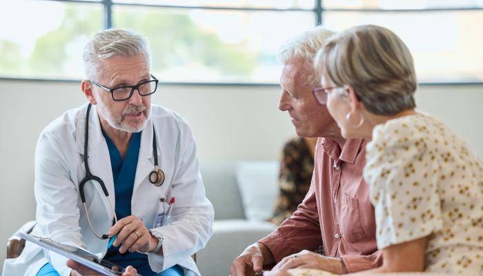 Doctor speaking with senior couple