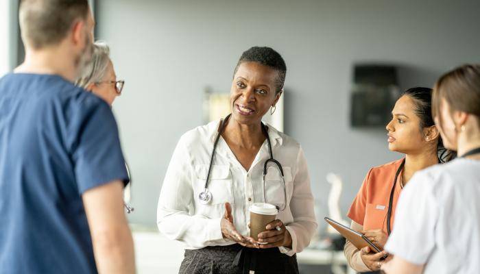 Clinical leadership speaking with other physicians 