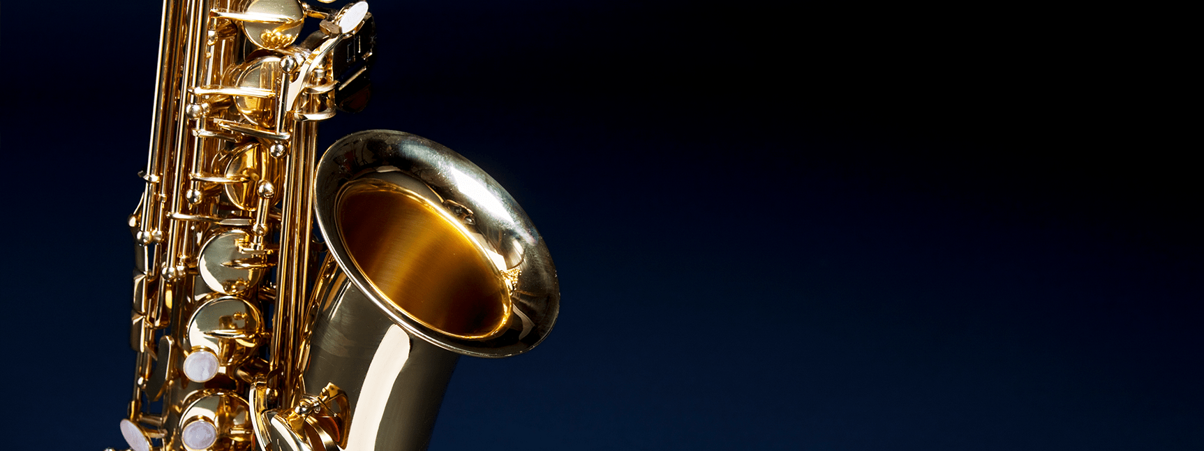 Saxophone in front of a black backbackground
