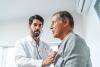 Doctor intently listening to patient heart with stethoscope