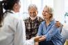 Senior couple speaking with doctor