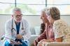 Doctor speaking with senior couple