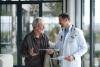 Doctor speaking to their senior patient as they walk together