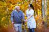 Physician walking with a patient outside in nature